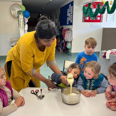 Children cooking with a Riverhills teacher