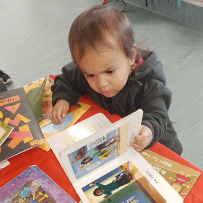 A Riverhills child sharing a book