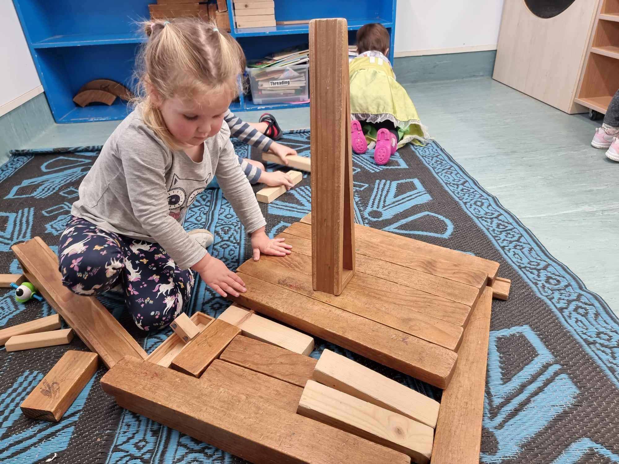 A Riverhills child exploring ideas with wooden blocks